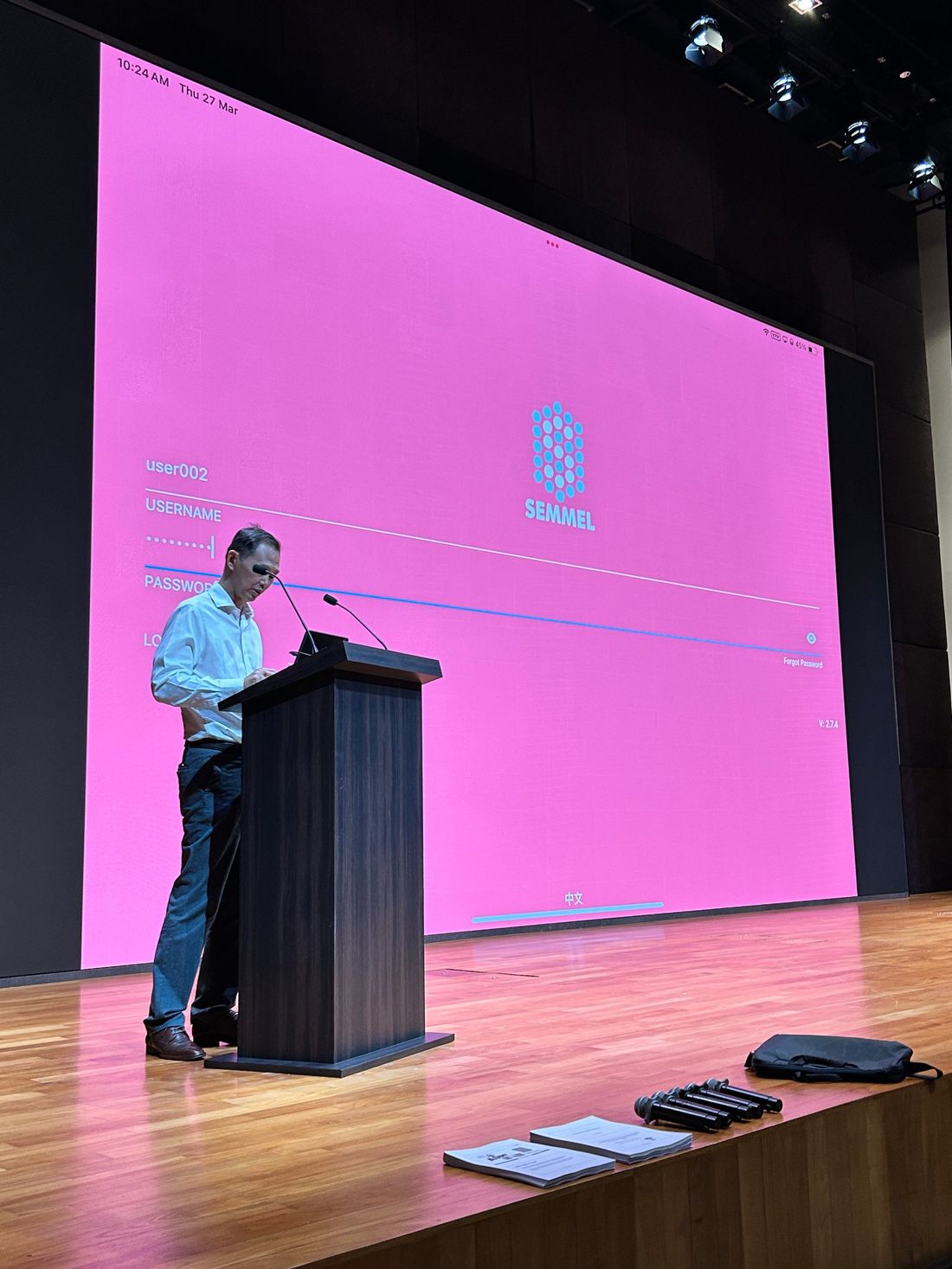 Kym Wong presenting SafetyOS on stage